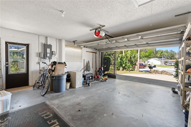 garage featuring a garage door opener and electric panel