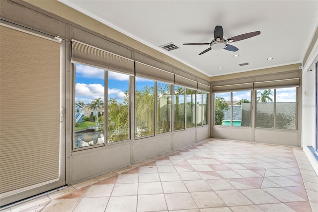 unfurnished sunroom featuring ceiling fan