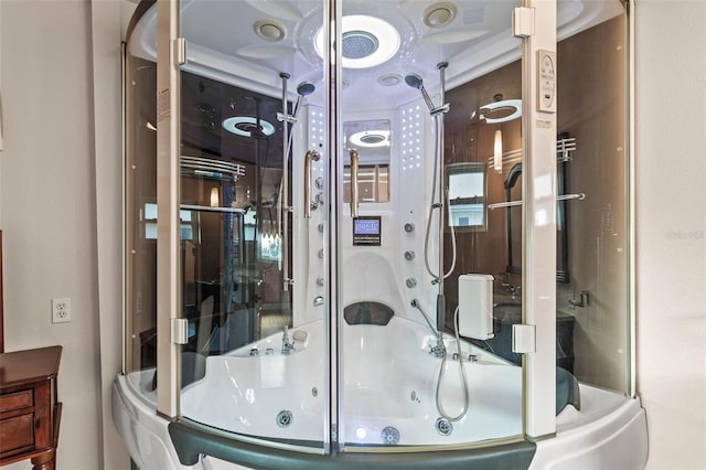 bathroom featuring crown molding and combined bath / shower with glass door