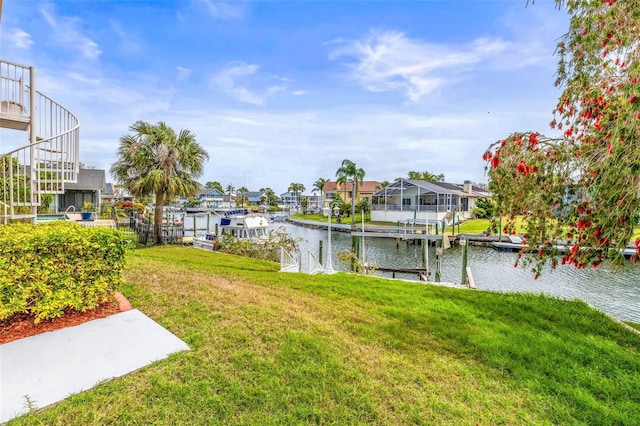 dock area with a lawn, a water view, and a residential view