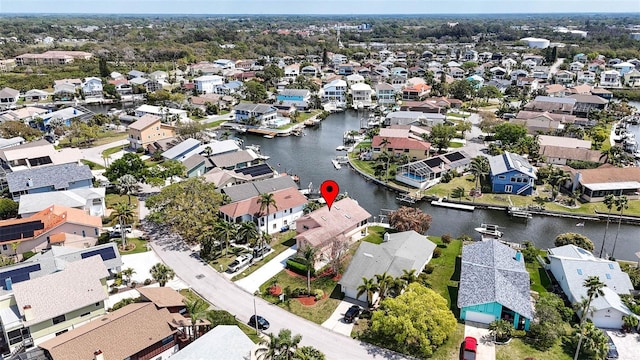 drone / aerial view with a residential view and a water view