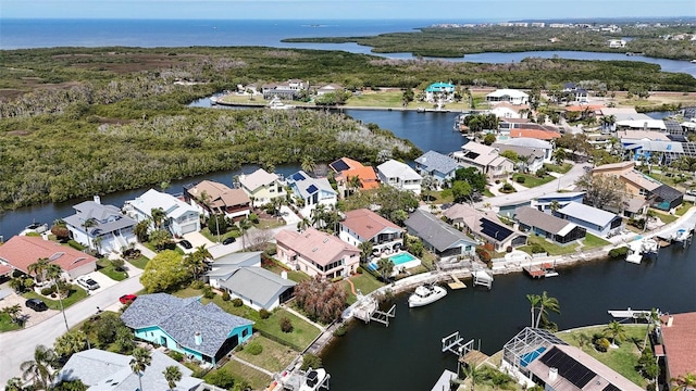 drone / aerial view featuring a water view and a residential view