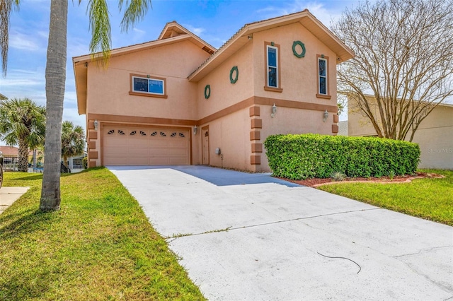 view of front of house with a front yard, driveway, stucco siding, and an attached garage