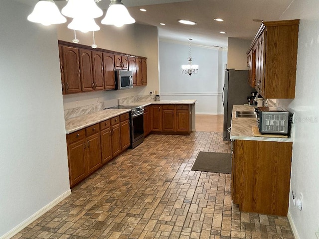 kitchen featuring appliances with stainless steel finishes, an inviting chandelier, and decorative light fixtures