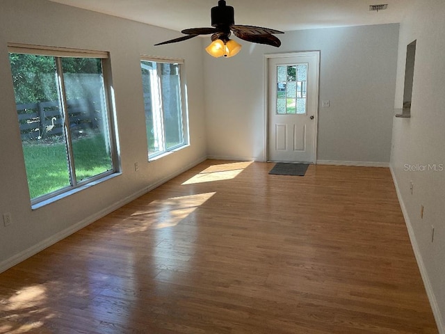 interior space featuring a healthy amount of sunlight, wood-type flooring, and ceiling fan