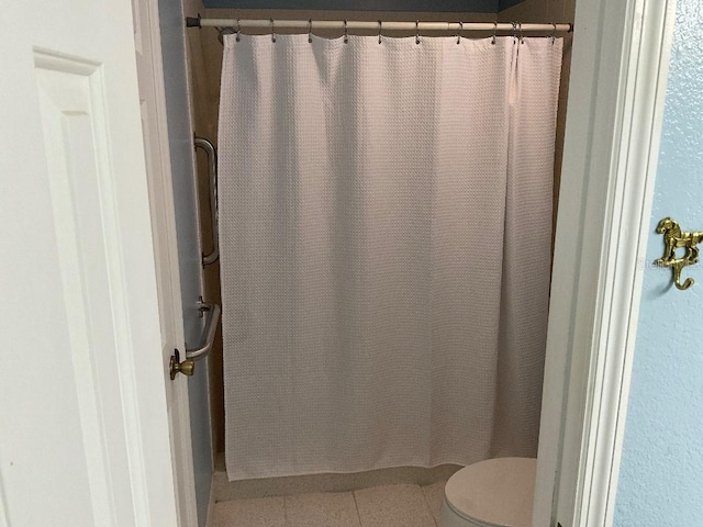 bathroom featuring toilet and tile patterned floors