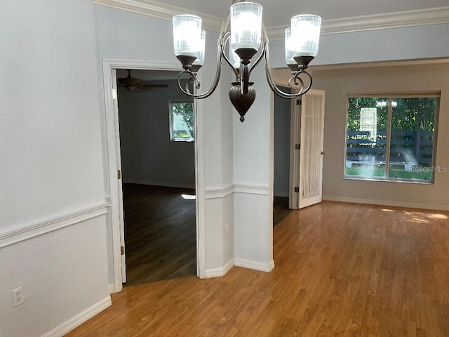 unfurnished dining area with ornamental molding and hardwood / wood-style flooring