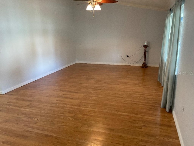 spare room with dark hardwood / wood-style floors and ceiling fan