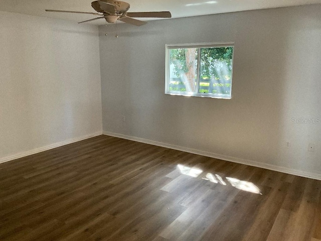 unfurnished room with dark hardwood / wood-style floors and ceiling fan