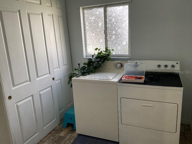 clothes washing area featuring washer and clothes dryer