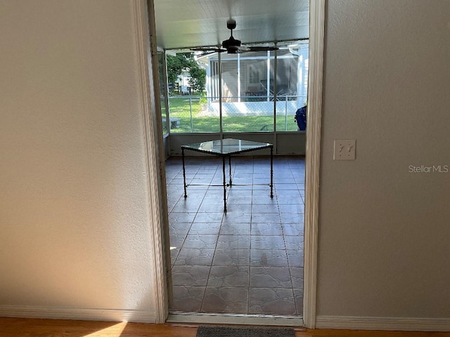 interior space featuring ceiling fan and tile patterned flooring