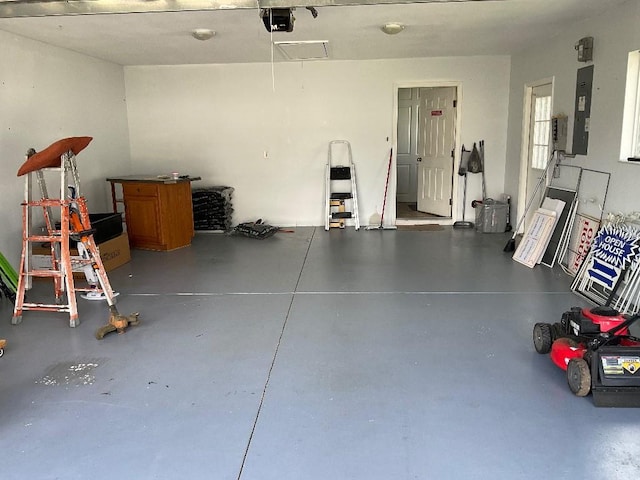 garage with a garage door opener and electric panel