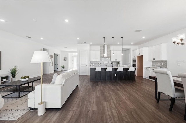 living room with sink and dark hardwood / wood-style floors