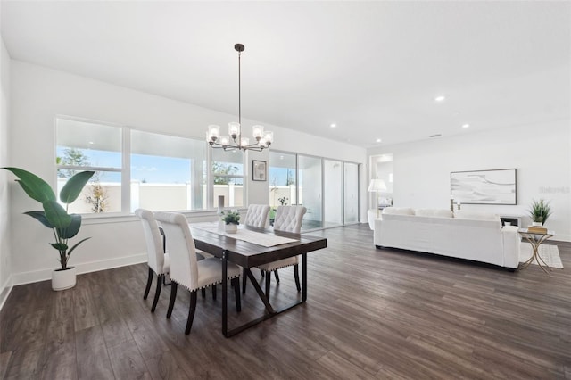 dining space with an inviting chandelier and dark hardwood / wood-style flooring