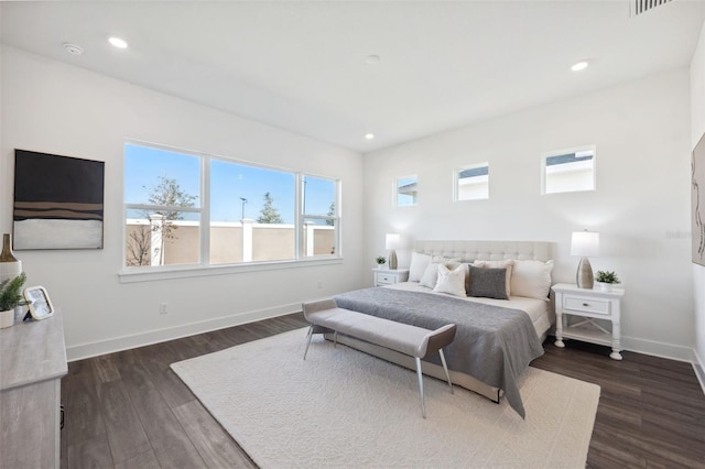 bedroom with dark hardwood / wood-style floors