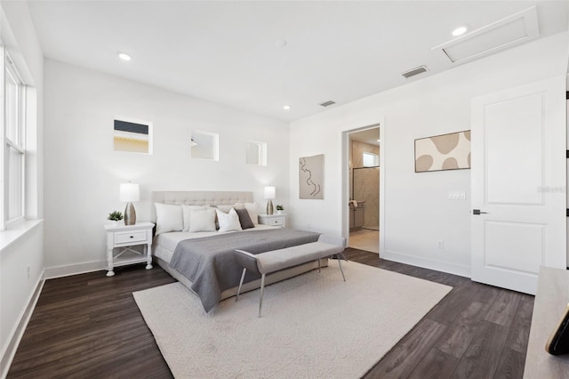 bedroom with ensuite bathroom and dark hardwood / wood-style flooring