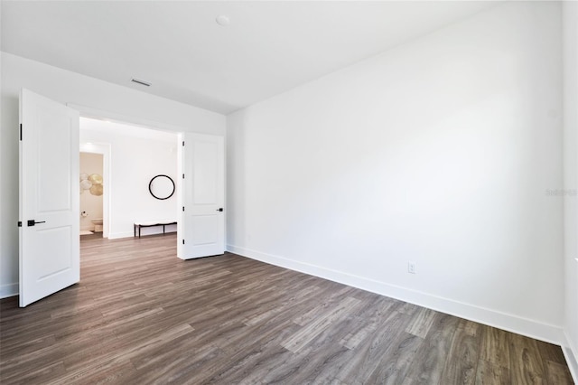 spare room featuring wood-type flooring