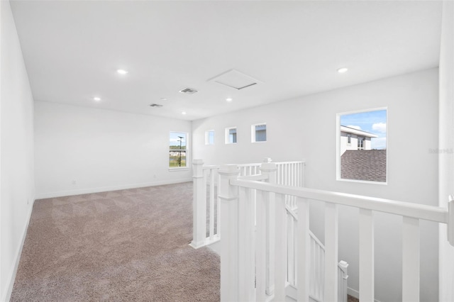 hallway featuring light carpet