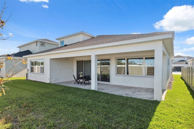 back of property with a patio and a lawn