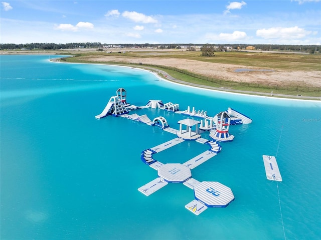 bird's eye view with a water view and a beach view