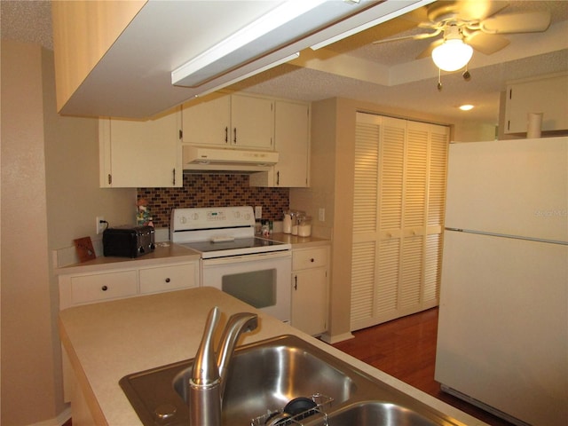 kitchen featuring decorative backsplash, white cabinets, ceiling fan, dark wood-type flooring, and white appliances