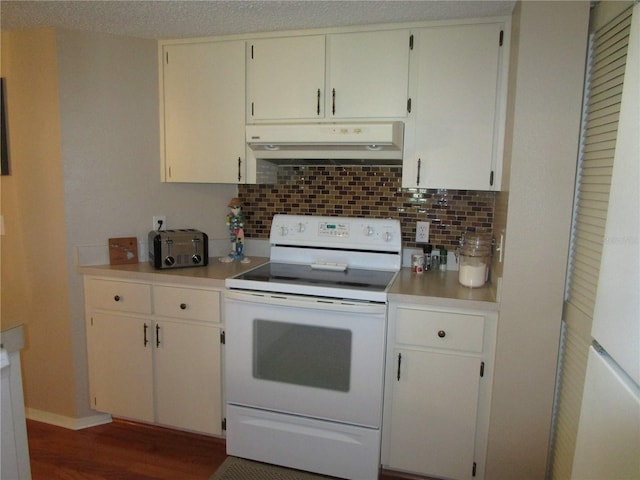 kitchen featuring white electric range oven, dark wood-type flooring, white cabinetry, and backsplash