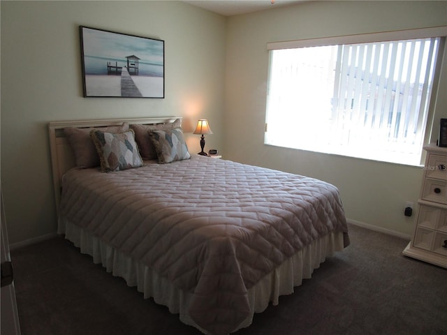 bedroom featuring dark colored carpet