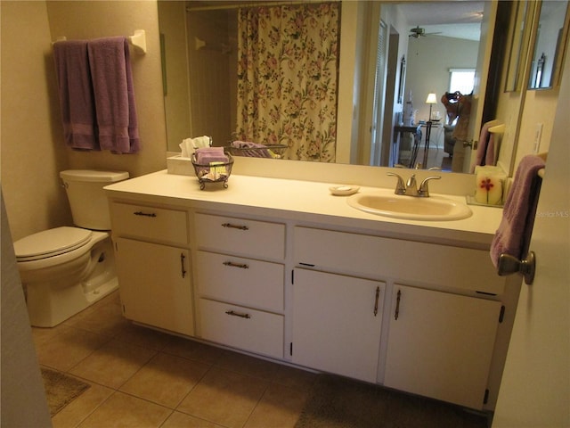 bathroom featuring vanity, toilet, tile patterned floors, and ceiling fan