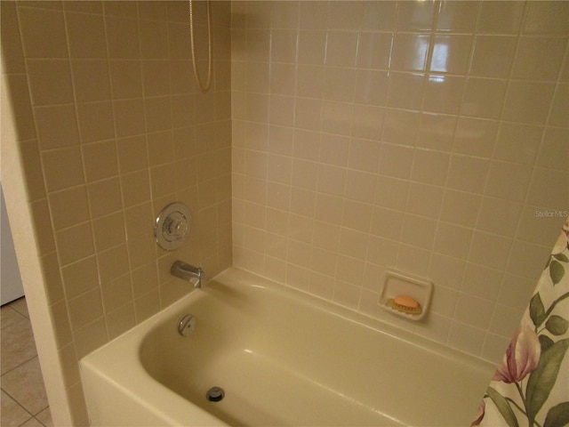 bathroom featuring shower / bath combo with shower curtain and tile patterned flooring