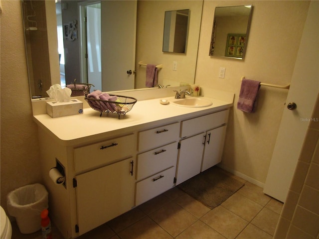 bathroom featuring vanity, toilet, and tile patterned flooring