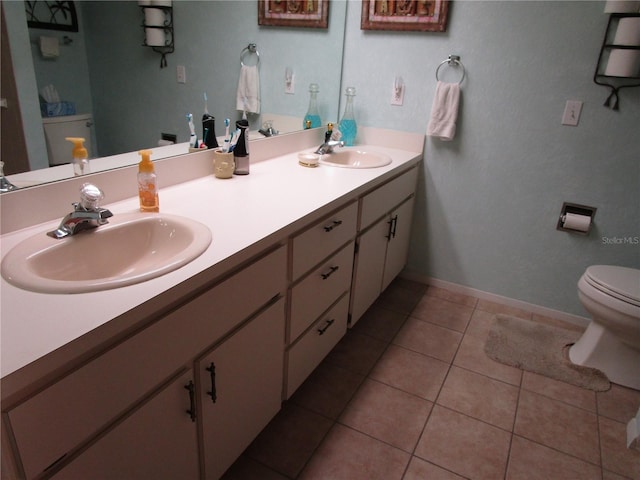 bathroom featuring vanity, toilet, and tile patterned floors