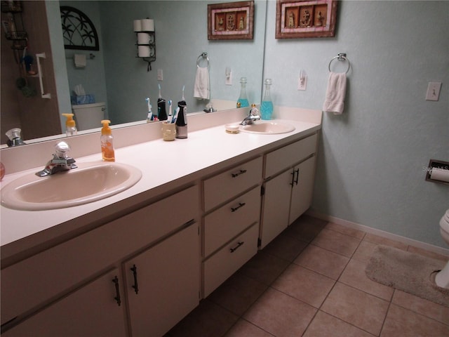 bathroom featuring toilet, vanity, and tile patterned flooring