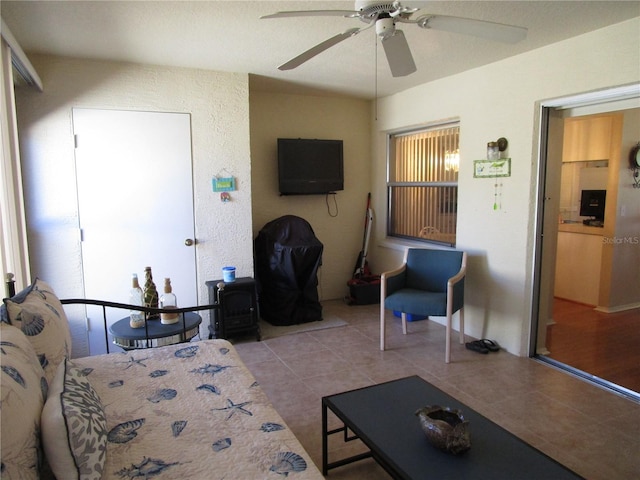 tiled living room with ceiling fan