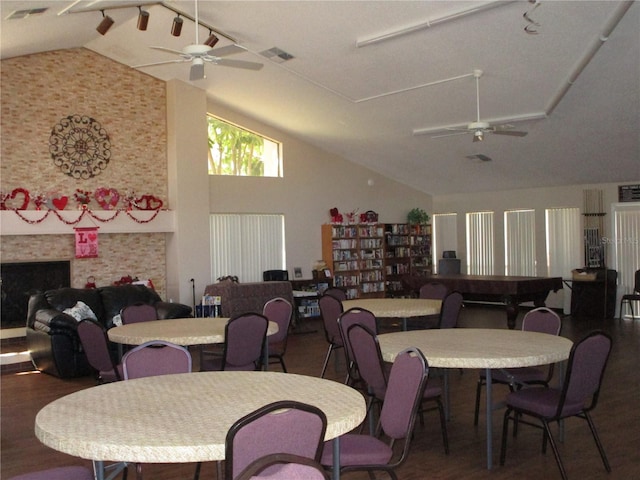 dining space featuring dark hardwood / wood-style flooring, vaulted ceiling, and ceiling fan