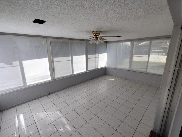 unfurnished sunroom with ceiling fan