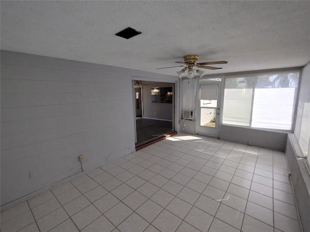 unfurnished sunroom featuring ceiling fan