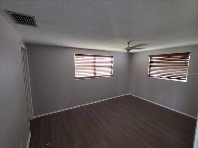 unfurnished room with a textured ceiling, ceiling fan, and dark hardwood / wood-style floors