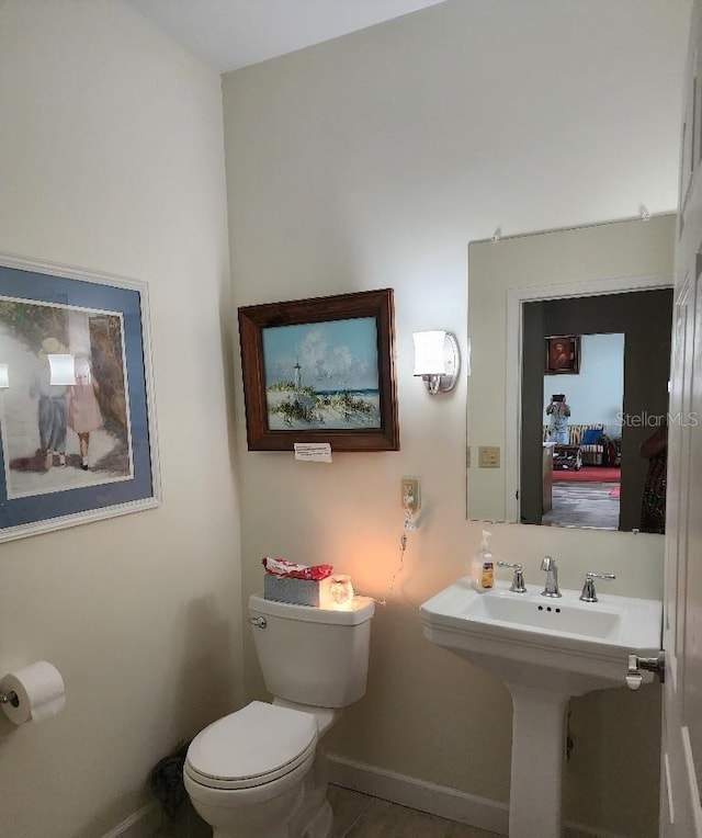 bathroom featuring toilet and tile patterned flooring