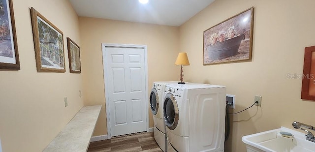 laundry room featuring sink, separate washer and dryer, and hardwood / wood-style floors