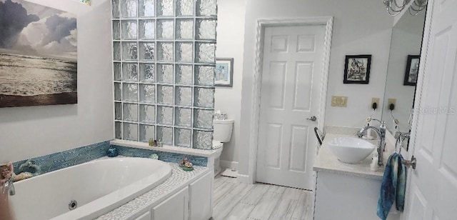 bathroom featuring vanity and a tub to relax in