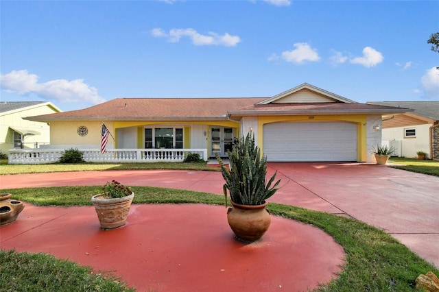 ranch-style house featuring covered porch and a garage