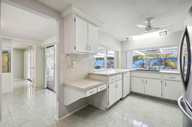 kitchen with sink, backsplash, white dishwasher, white cabinetry, and ceiling fan