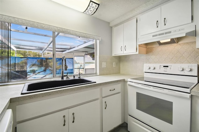 kitchen featuring decorative backsplash, white cabinets, sink, and white appliances