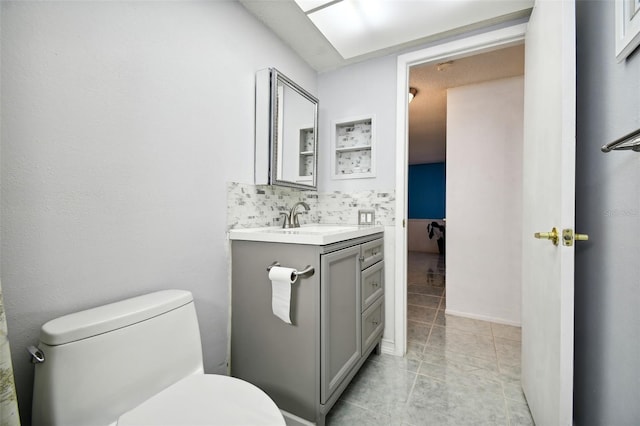 bathroom featuring toilet, vanity, and tile patterned flooring