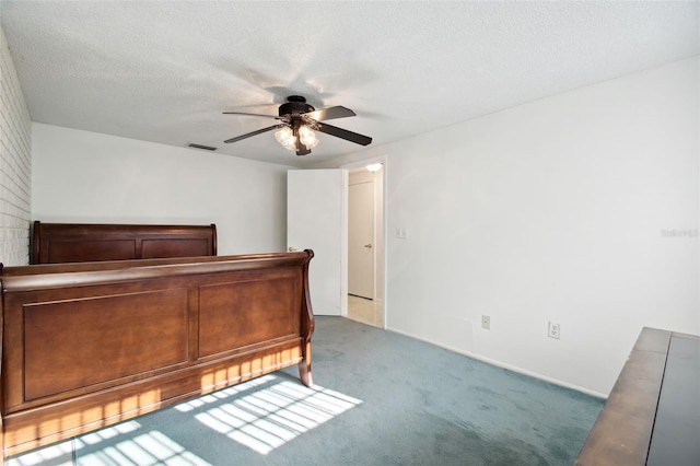 carpeted bedroom with a textured ceiling and ceiling fan