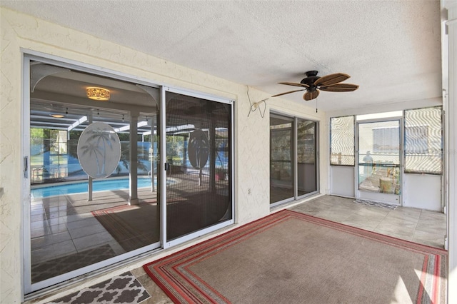 sunroom featuring ceiling fan