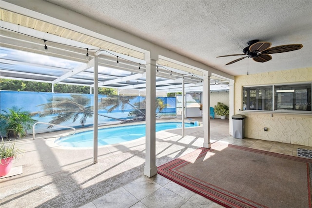 view of pool featuring ceiling fan, a patio, and a lanai