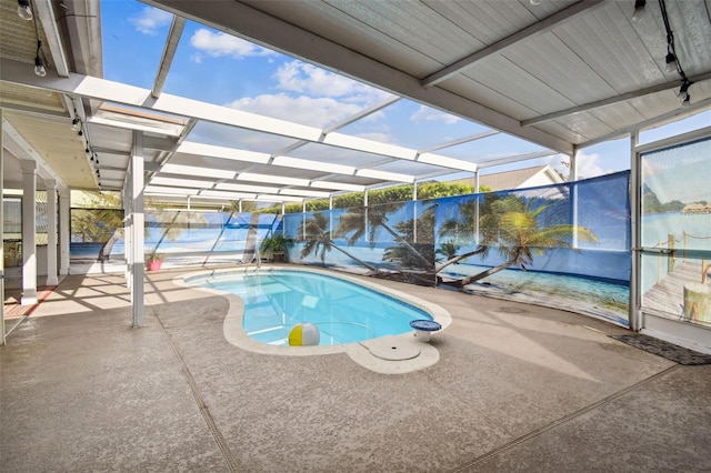 view of swimming pool with a patio area and a lanai