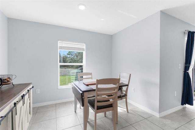 dining space featuring light tile patterned floors