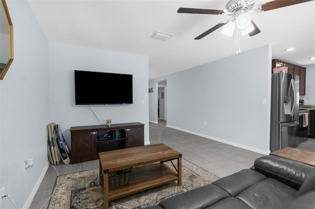 living room featuring light tile patterned floors and ceiling fan